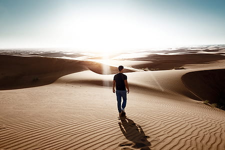 man standing on desert field during daytime thumbnail