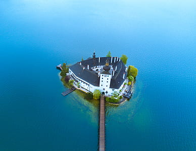 aerial view photography of islet with house and dock thumbnail