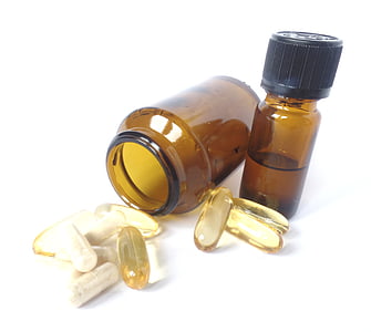 two amber glass bottles with brown gel medicine pills thumbnail