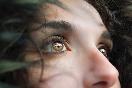 close up photography of woman's face with brown eyes thumbnail