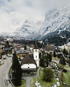 concrete houses near ice-capped mountain at daytime thumbnail