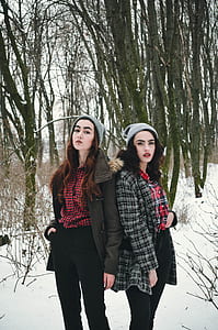 two women posting beside trees thumbnail