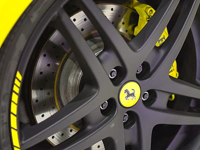 close-up photography of black Ferrari wheel and tire with silver brake disc rotor and yellow caliper thumbnail
