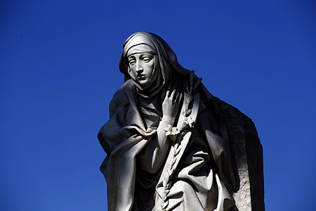 nun statue under blue sky thumbnail