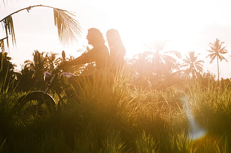 silhouette of man and woman riding motorcycle thumbnail