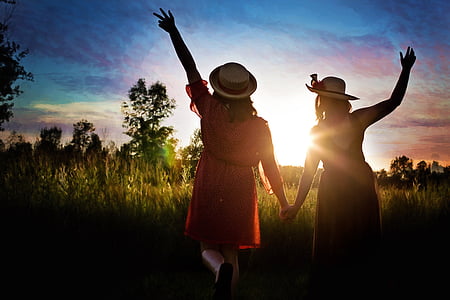 two women walking towards sunlight thumbnail
