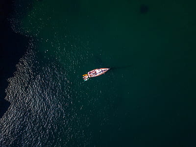 aerial photo of white and red boat during daytime thumbnail