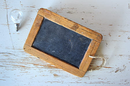 rectangular brown wooden framed board and incandescent bulb thumbnail