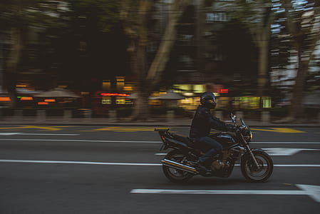 time-lapsed photo of man riding motorcycle thumbnail