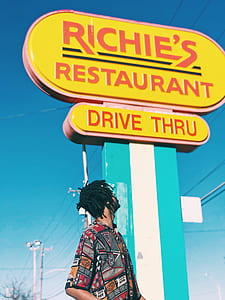man looking at Richie's Restaurant drive thru signage thumbnail