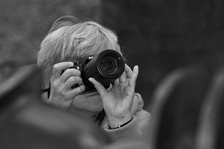 grayscale selective focus photography of woman taking picture above thumbnail
