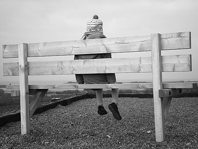 grayscale photo of girl sitting on bench thumbnail