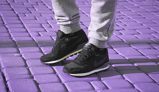 person wearing black Nike sneakes thumbnail