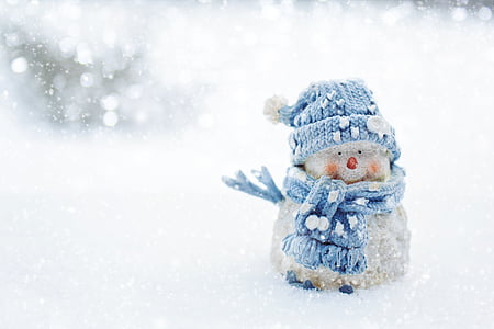 snowman wearing knit cap in snow thumbnail