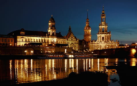 pointed building with lights on under blue sky thumbnail