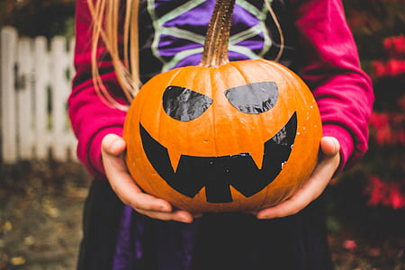 girl holding pumpkin head thumbnail