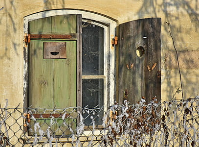 green wooden window on beige house thumbnail