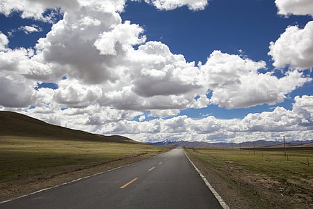 concrete highway with mountains in distance thumbnail