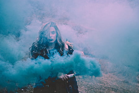 woman with black jacket holding bar-releasing-smoke thumbnail