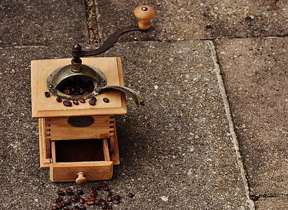 brown and black coffee grinder on gray surface thumbnail
