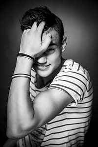 Greyscale Photo of Man in Striped Shirt thumbnail