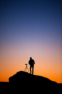 silhouette photography of man with camera thumbnail
