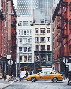 yellow sedan on street thumbnail