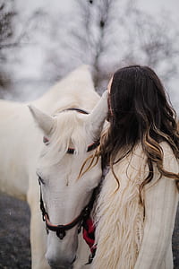 woman standing beside white horse outside thumbnail
