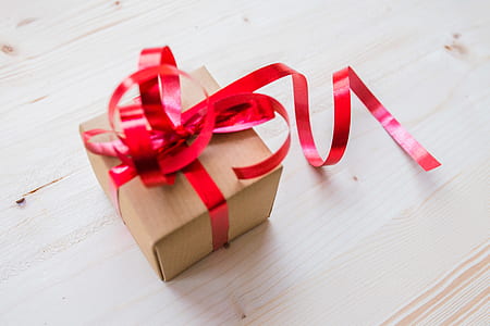 Red Ribbon on Brown Cardboard Box thumbnail