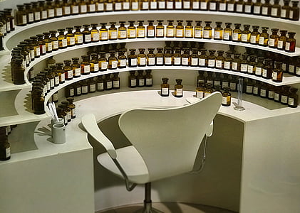 chair surrounded by bottles on table thumbnail