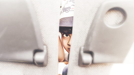 person looking between gray board thumbnail