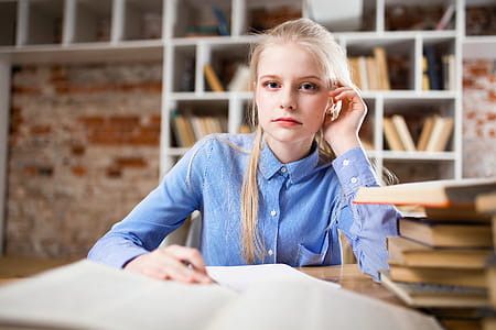 Woman Sitting Next to Table and Right Hand on Ear thumbnail