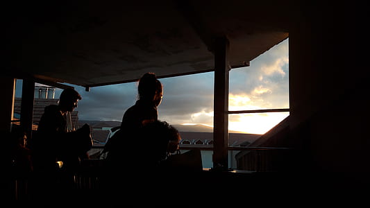 silhouette photo of two persons near glass window thumbnail