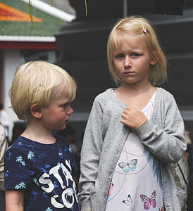 Boy Wearing Blue and White Stay Cool Print Crew-neck T-shirt Next to Girl Wearing White and Teal Butterfly Printed Scoop-neck Shirt and Gray Open Long-sleeved Cardigan thumbnail