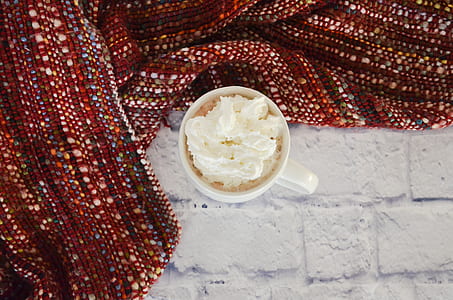 white mug surrounded with red textile thumbnail
