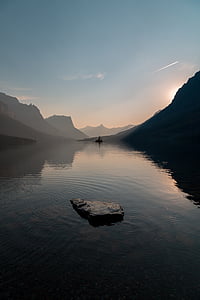 lake near mountain range under calming sky thumbnail