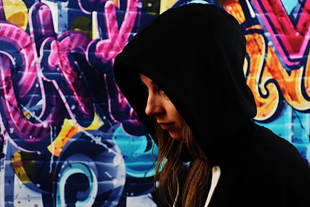 woman wearing hoodie with graffiti background thumbnail