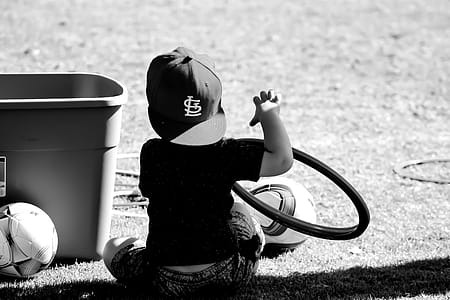 Grayscale Photo of Boy Wearing St. Louis Cap thumbnail