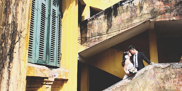 man and woman standing on building thumbnail