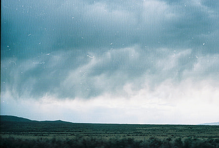 green grassfield under cloudy sky thumbnail