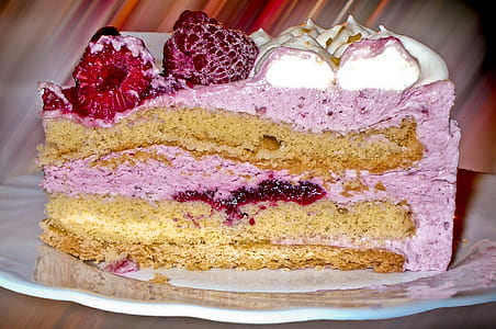 slice of cake with raspberry topping on plate thumbnail