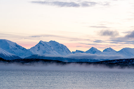 snow-covered mountain beside lake thumbnail
