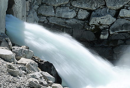 waterfalls near rock formation thumbnail