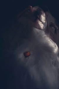 woman wearing white lace bridal gown with orange fruit thumbnail