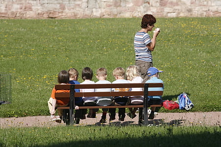 children sitting on wooden bench thumbnail