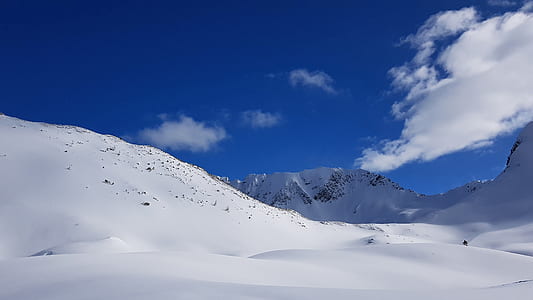 snow coated mountain under blue sky thumbnail