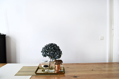 gray hydrangeas centerpiece on brown wooden table thumbnail