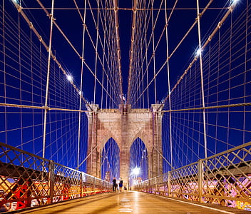 people walking on Brooklyn Bridge during nighttime thumbnail