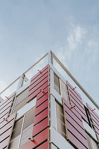 low angle photography of white and red building thumbnail