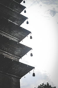black and brown building under white clouds thumbnail